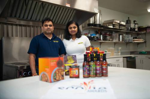 Amila Rajakaruna and his wife Arshala Dona, the owners of Tasty Heat’s Hot Sauces & Spicy Foods, show off their line of products in a community kitchen they rent to prepare their sauces. (Ethan Cairns / Winnipeg Free Press)