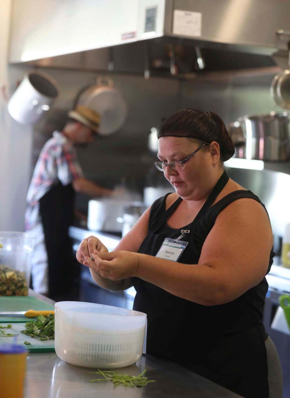 Head chef Grant Mitchell (left) and volunteer chef Marsha Barber prepare lunch.