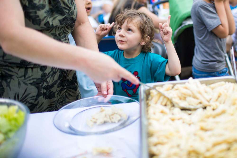 Michelle Canto serves her three-year-old son Guil Burd. (Mikaela MacKenzie / Winnipeg Free Press)