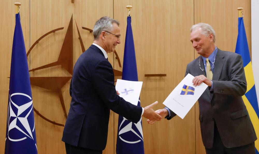 Johanna Geron/Pool via AP
NATO Secretary-General Jens Stoltenberg and Sweden’s Ambassador to NATO Axel Wernhoff shake hands during a May 18 ceremony in Brusssels to mark Sweden’s and Finland’s application for NATO membership.