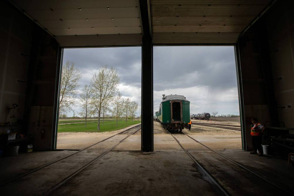 Prairie Dog Central volunteers park the train in the maintenance shed after taking a group of school kids out on a field trip. (Daniel Crump / Winnipeg Free Press)
