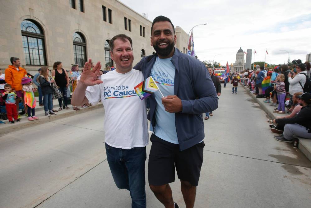 JOHN WOODS / WINNIPEG FREE PRESS
PC MLAs Shannon Martin and Obby Khan take part in the Pride Parade in downtown Winnipeg Sunday. The premier said she was unable to march in the parade due to a scheduling conflict and a miscommunication between her staff and Pride Winnipeg organizers.