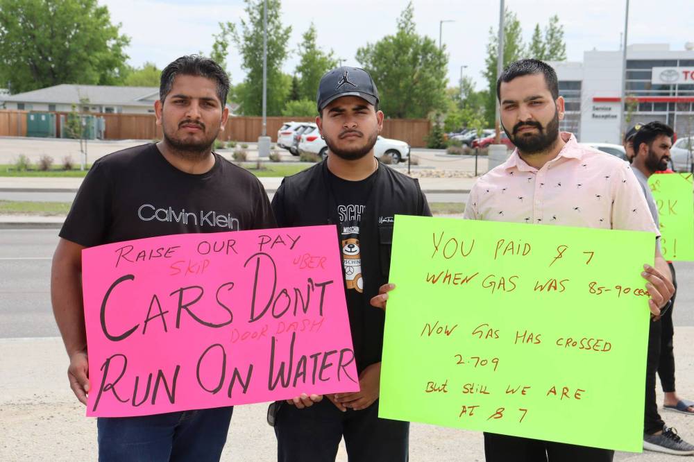 BRYCE HUNT / WINNIPEG FREE PRESS
Left to right: Manpreet Gill, Arjun Khera, Kuldeep Dhillon holding signs on a Regent Avenue sidewalk to strike against food delivery services.