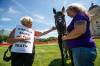 Gail Holm (left) pats rescue horse Dayo, as she speaks with Corinne Nykorak during a protest against live horse exports at the Manitoba legislature Saturday afternoon. (Daniel Crump / Winnipeg Free Press)