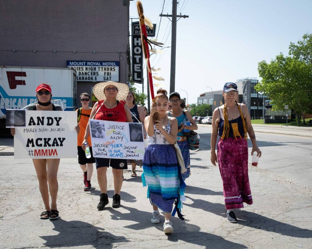 JESSICA LEE / WINNIPEG FREE PRESS
Callie Starr, 16, (in blue ribbon skirt) leads the Warriors’ Walk Sunday near Higgins Avenue and Main Street to honour missing and murdered Indigenous boys and men.