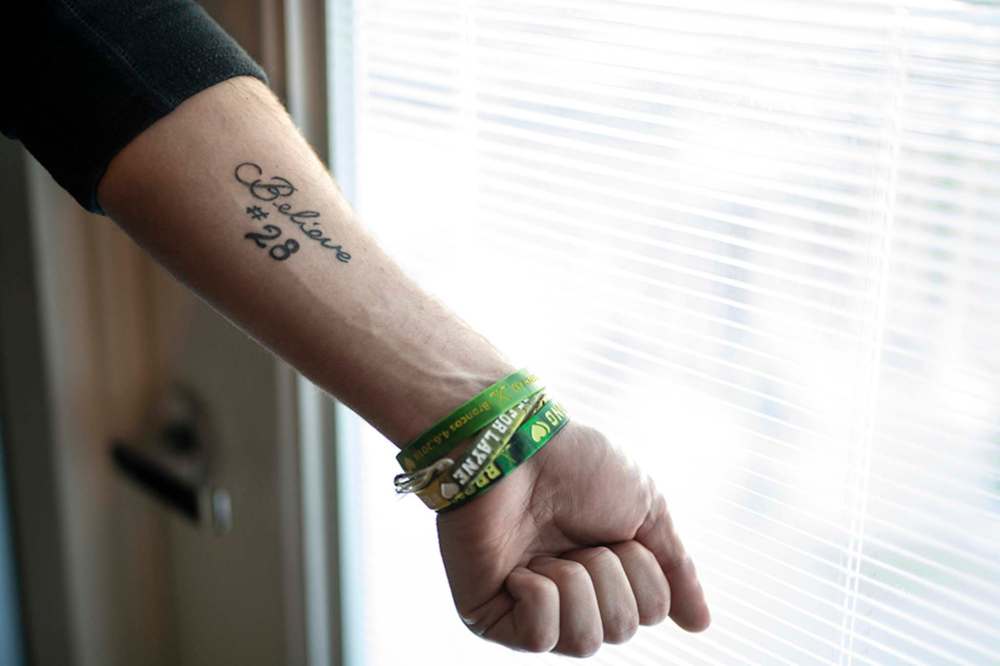 Humboldt bus crash survivor Layne Matechuk displays a tattoo, which reads 'Believe' and the number 28, that he got recently in memory of the crash. (Liam Richards / The Canadian Press)