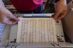 SASHA SEFTER / WINNIPEG FREE PRESS
The sheet music is then retrofitted to a coil binding by punching holes into the paper.
