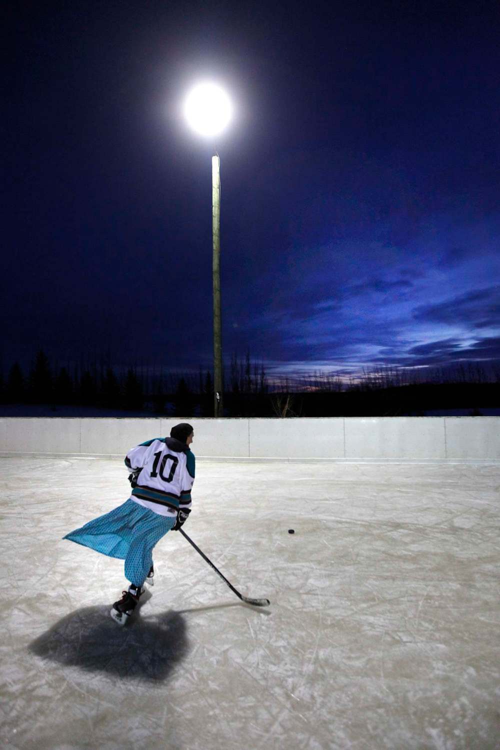 DECEMBER 2017: Tirzah Maendel, a member of a women’s Hutterite hockey team, circles the ice at the Baker colony.