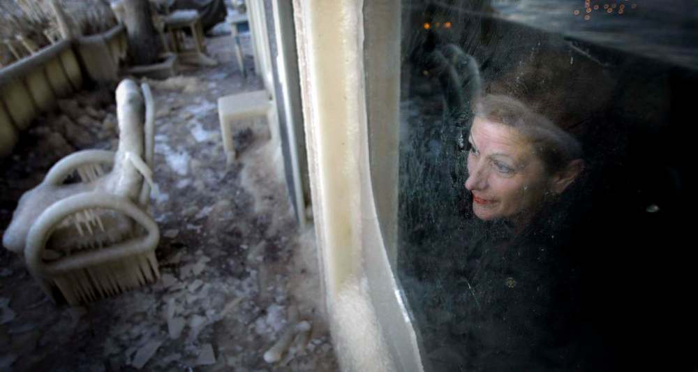 NOVEMBER 2005: Leo Sawicki surveys the damage at her Gimli home following a winter storm.