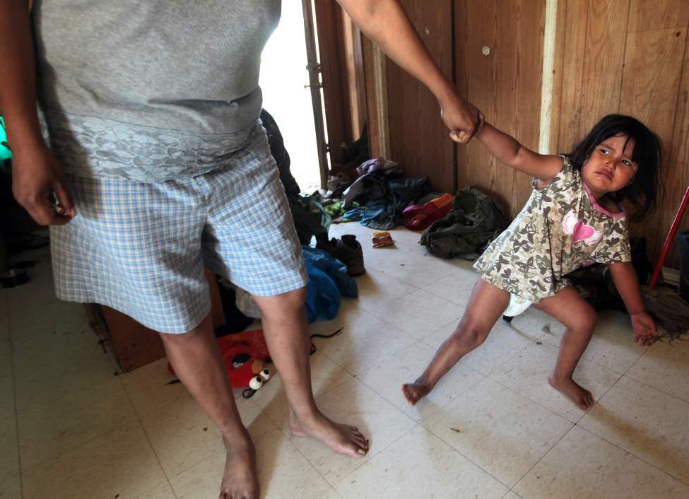 JOE.BRYKSA@FREEPRESS.MB.CA
Youngster Tannis, 3, yanks on her mother's arm. The Little family is now forced to haul their water in pails because of a contaminated cistern that was making the family sick.