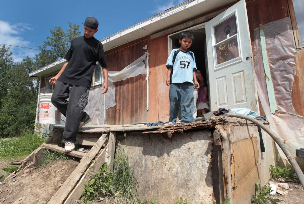 JOE.BRYKSA@FREEPRESS.MB.CA
Solomon McPherson carries a slop pail full of sewage to a makeshift dump just outside his family's home at Garden Hill First Nation. The home has no running water.