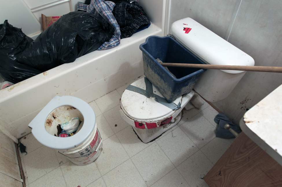 JOE.BRYKSA@FREEPRESS.MB.CA
A slop pail full of sewage sits next to an unconnected toilet. The water does not connect to this house anymore because of problems with the water line.