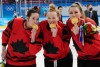 CP
Team Canada's Melodie Daoust (15), Sarah Fillier (10) and Natalie Spooner (24) celebrate with their gold medals after defeating the United States in women's hockey gold medal game action at the 2022 Winter Olympics in Beijing on Thursday, Feb. 17, 2022. (Ryan Remiorz / The Canadian Press)