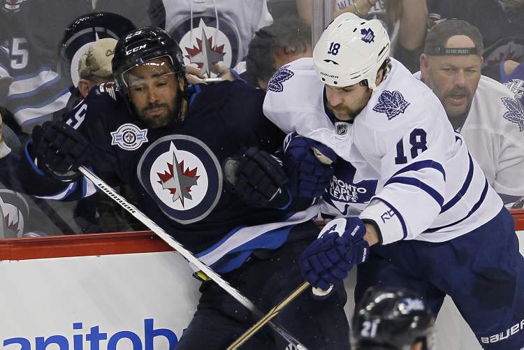 John Woods / Winnipeg Free Press
Winnipeg Jets' Johnny Oduya gets hit hard by Toronto Maple Leafs' Mike Brown (18) during first-period actionat the MTS Centre Tuesday.