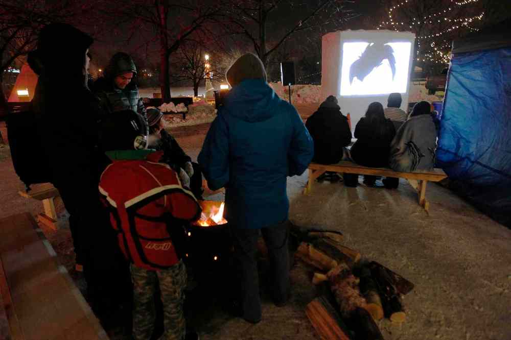 JOHN WOODS / WINNIPEG FREE PRESS
People enjoy a free outdoor screening of eight short films during the sixth annual Canadian Sport Film Festival at The Forks Saturday.