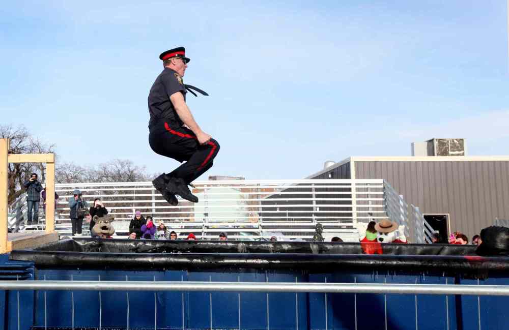 RUTH BONNEVILLE / WINNIPEG FREE PRESS
Police officer Cam Baldwin braces himself as he takes the plunge Saturday afternoon. Baldwin raised $2,875 in pledges, the most raised by a single individual for the event.