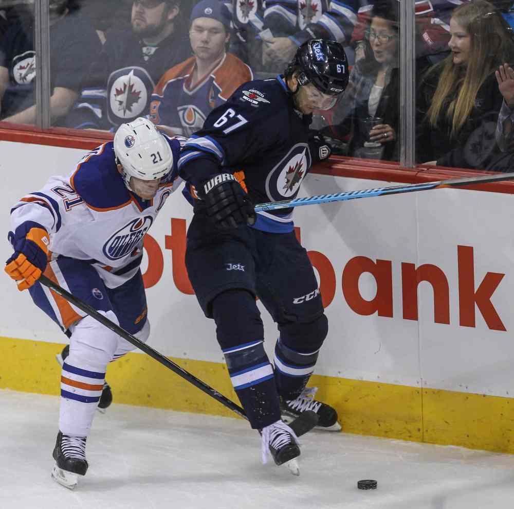 MIKE DEAL / WINNIPEG FREE PRESS
Winnipeg Jets Michael Frolik (67) tries to keep the puck from the Edmonton Oilers' Andrew Ference (21) in the first period of Wednesday's game.