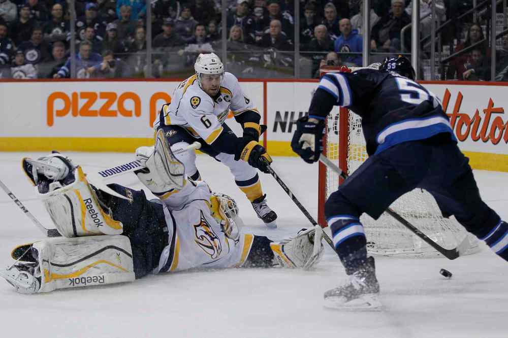 John Woods / Winnipeg Free Press
Winnipeg Jets' Mark Scheifele (55) gets around Nashville Predators' goaltender Carter Hutton (30) just before shooting the puck off Shea Weber (6) for the goal.