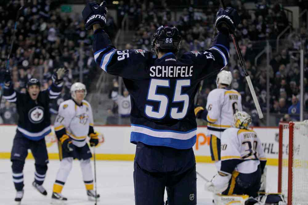 John Woods / Winnipeg Free Press
Winnipeg Jets' Mark Scheifele (55) celebrates his second-period goal on Nashville Predators' goaltender Carter Hutton (30) during Tuesday's game in Winnipeg.