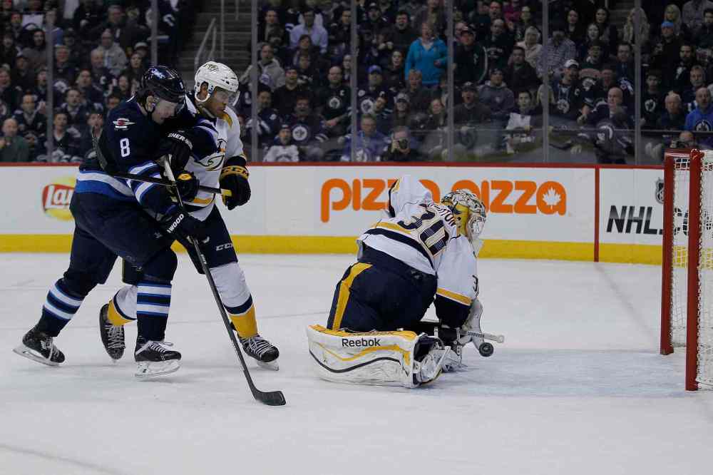 John Woods / Winnipeg Free Press
Nashville Predators' goaltender Carter Hutton's (30) save goes off of his own leg for the goal by Winnipeg Jets' Blake Wheeler's (26) as Jets' Jacob Trouba (8) and Preds' Seth Jones (3) look on during second period in Winnipeg Tuesday.