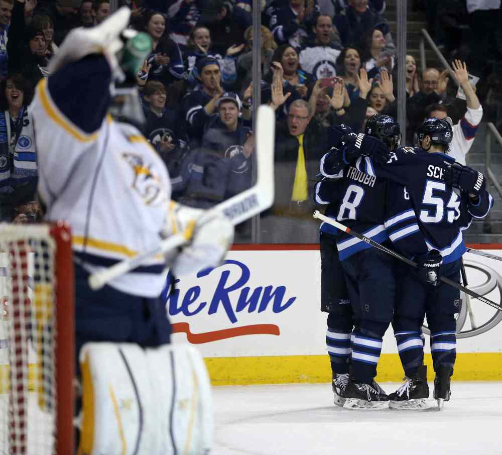 Trevor Hagan / The Canadian Press
Winnipeg Jets players celebrate a goal by teammate Blake Wheeler (26) after he beat Nashville Predators' goaltender Carter Hutton (30) during second period NHL hockey action in Winnipeg.
