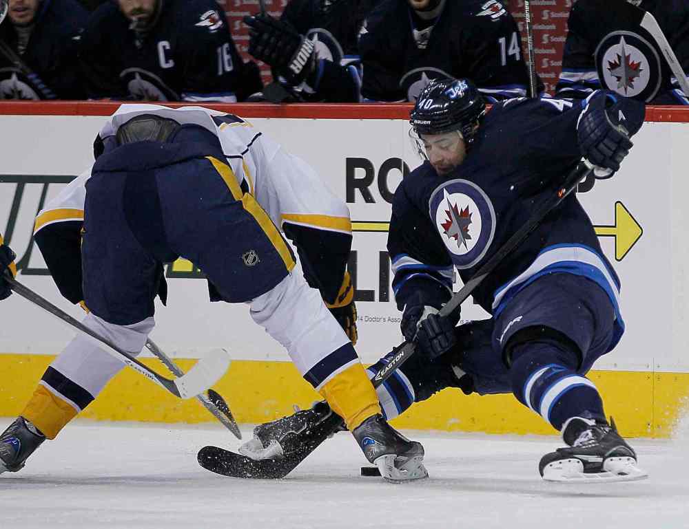 John Woods / Winnipeg Free Press
Winnipeg Jets' Devin Setoguchi (40) fights for the puck with Nashville Predators' Patric Hornqvist (27) during the second period of Tuesday's game at MTS Centre.