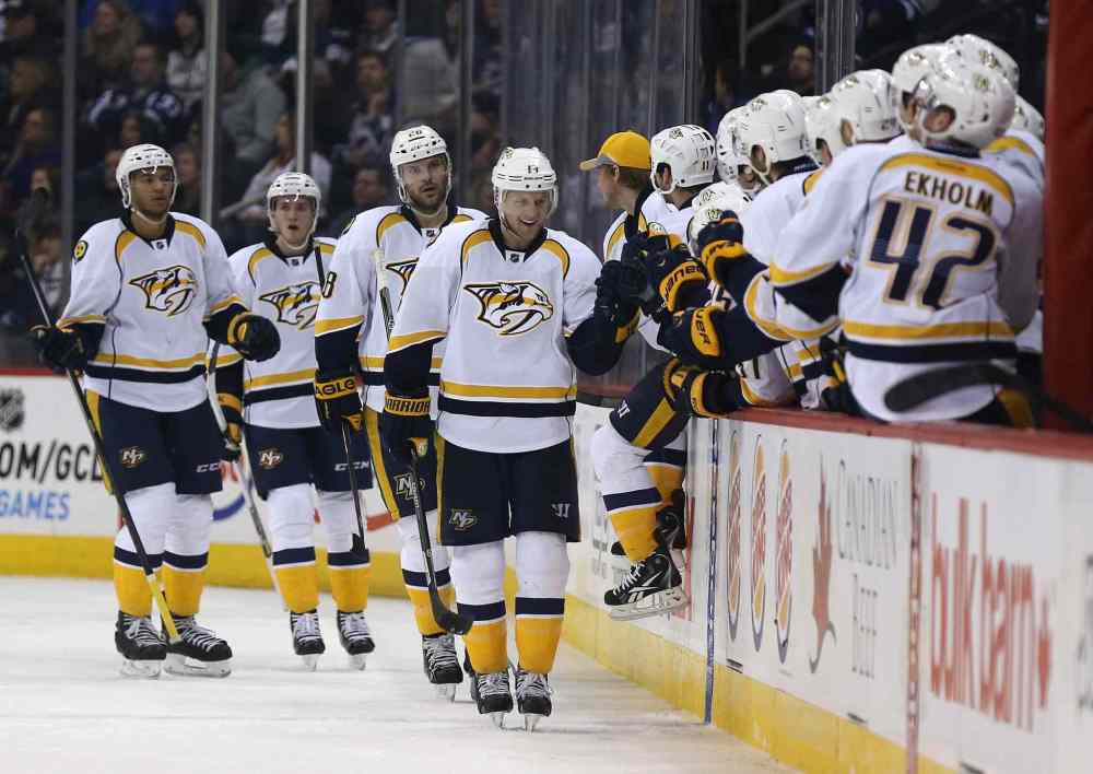 Trevor Hagan / The Canadian Press
Nashville Predators players celebrate a second-period goal by Nick Spaling (13) against the Winnipeg Jets at the MTS Centre Tuesday.
