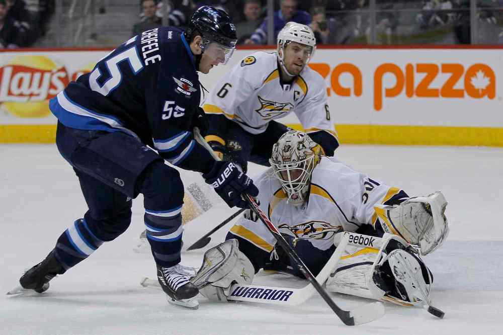 John Woods / Winnipeg Free Press
Winnipeg Jets' Mark Scheifele (55) gets around Nashville Predators' goaltender Carter Hutton (30) just before shooting the puck off of Shea Weber (6) for a second-period goal Tuesday.