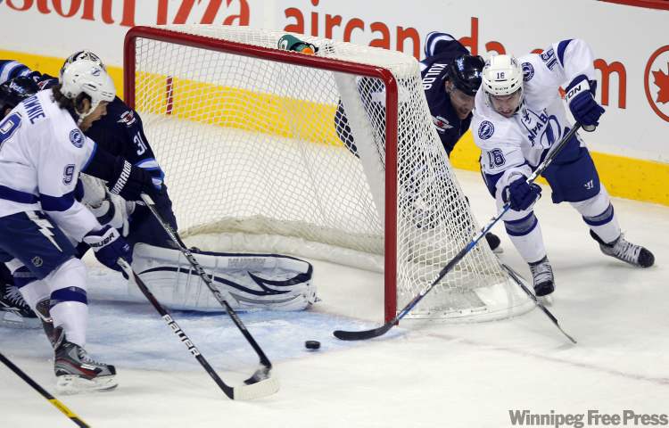 Bo Winnipeg Free Press
The Tampa Bay Lightning's Teddy Purcell tries to wrap the puck around and in the Winnipeg Jets' net during the second period Monday. The attempt was unsuccessful.