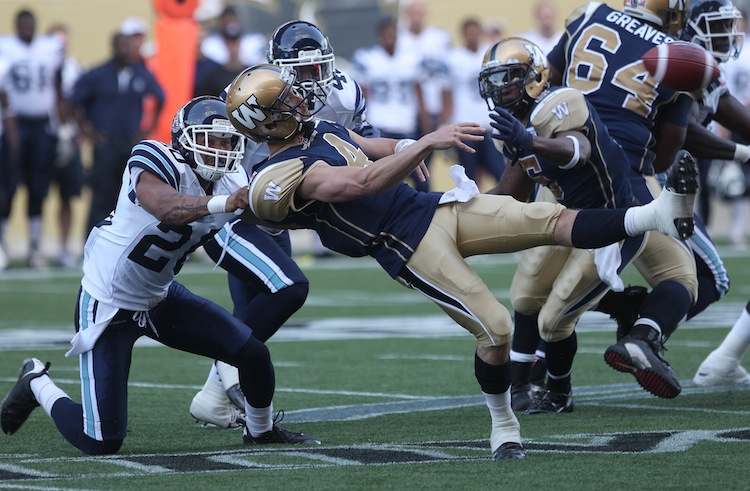 JOE BRYKSA / WINNIPEG FREE PRESS
Winnipeg Blue Bombers quarterback Buck Pierce gets sacked by Bryan Payton of the Toronto Argonauts early in the first quarter of their pre-season game at Investors Group Field Wednesday night.