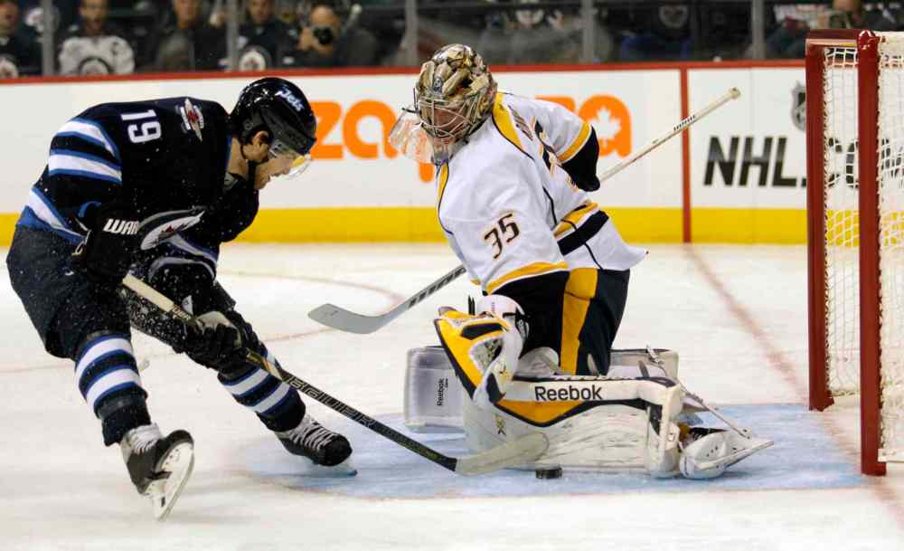 JOE BRYKSA / WINNIPEG FREE PRESS
Winnipeg Jets Jim Slater, left, runs at Nashville Predators' goaltender Pekka Rinne on a breakaway during second-period NHL action in Winnipeg Friday night.