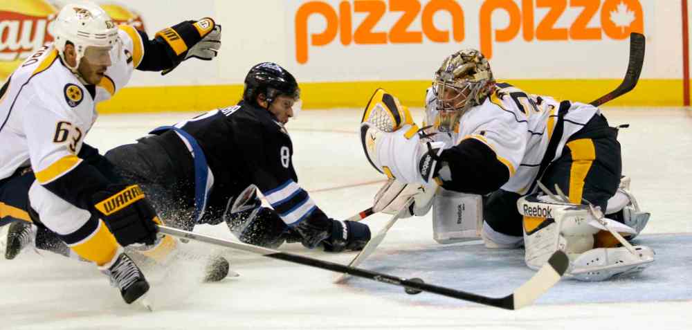 JOE BRYKSA / WINNIPEG FREE PRESS
Winnipeg Jets Jacob Trouba, center, collides with Nashville Predators goaltender Pekka Rinne as his teammate Mike Ribeiro, left, gives chase during the second period of Friday's home opener.
