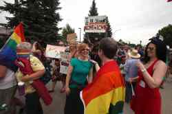 RUTH BONNEVILLE / WINNIPEG FREE PRESS
Michelle McHale (right, red dress)  and her partner Karen Phillips (rainbow flag over back) celebrate with friends and supporters.