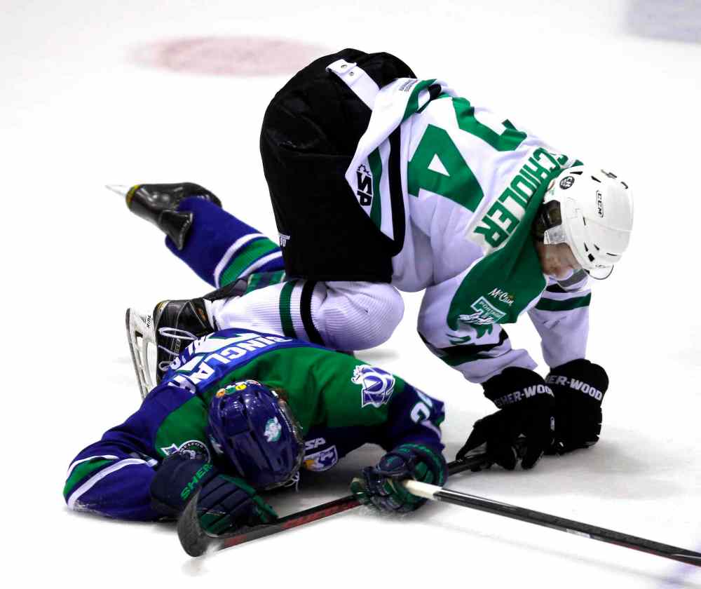 BORIS MINKEVICH / WINNIPEG FREE PRESS
Portage Dane Schioler #24 on top of Melforts Eric Sinclair during the first period of play.