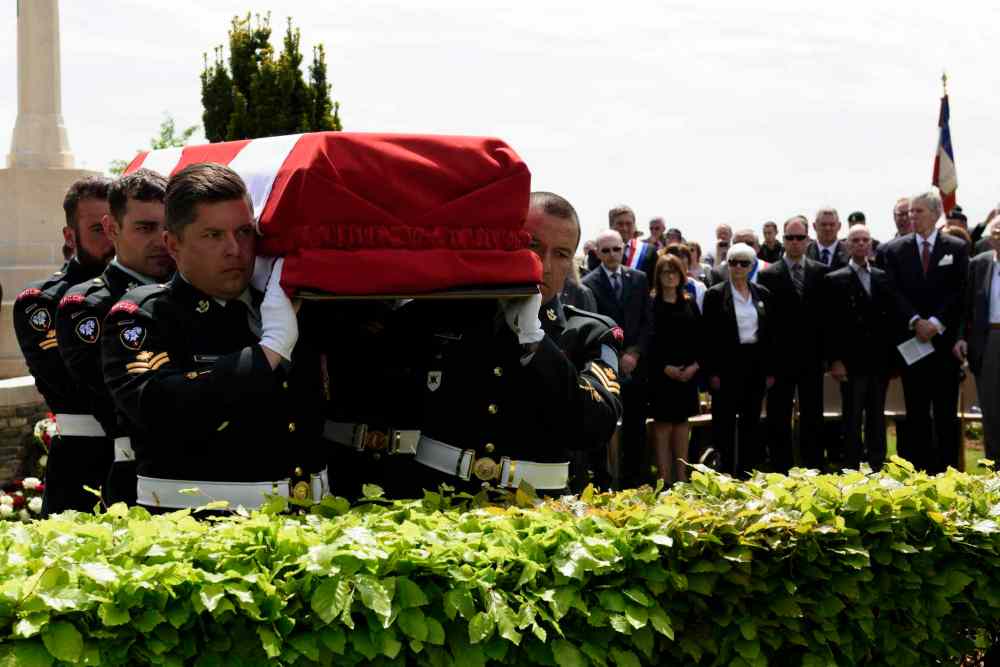 Corporal Jordan Lobb, Canadian Forces Joint Imagery Center, Ottawa
Members of the burial party from the Second Battalion Princess Patricia's Canadian Light Infantry carry an unknown soldier to his final resting place during the burial of eight Canadian First World War soldiers from the 78th Battalion at the Caix British Cemetery in Caix, France on 13 May 2015 as part of the largest single find of unknown Canadian soldiers since the Canadian Armed Forces Casualty Identification program started in 2006.