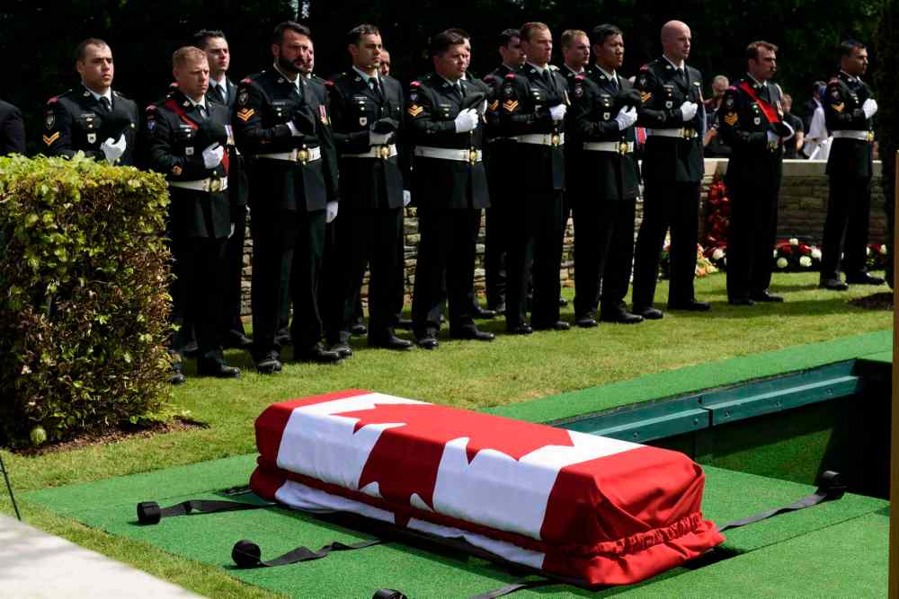 Corporal Jordan Lobb, Canadian Forces Joint Imagery Center, Ottawa
Members of the burial party from the Second Battalion Princess Patricia's Canadian Light Infantry remove headdress during the burial of eight Canadian First World War soldiers from the 78th Battalion at the Caix British Cemetery in Caix, France on 13 May 2015 as part of the largest single find of unknown Canadian soldiers since the Canadian Armed Forces Casualty Identification program started in 2006.