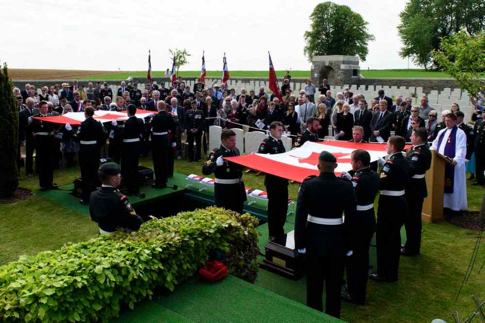 Corporal Jordan Lobb, Canadian Forces Joint Imagery Center, Ottawa
Members of the burial party from the Second Battalion Princess Patricia's Canadian Light Infantry prepare to fold the casket flags during the burial of eight Canadian First World War soldiers from the 78th Battalion at the Caix British Cemetery in Caix, France on 13 May 2015 as part of the largest single find of unknown Canadian soldiers since the Canadian Armed Forces Casualty Identification program started in 2006.