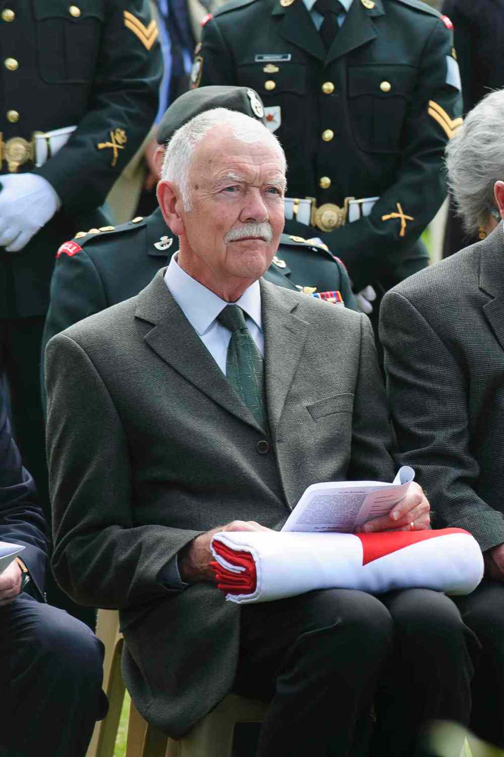 Corporal Jordan Lobb, Canadian Forces Joint Imagery Center, Ottawa
Don Gibbons, grand-nephew of Private Sidney Halliday, holds the Canadian flag presented to him during the ceremony at the burial of eight Canadian First World War soldiers from the 78th Battalion at the Caix British Cemetery in Caix, France on 13 May 2015. This burial was the largest of its kind since the Canadian Armed Forces Casualty Identification program started in 2006.
