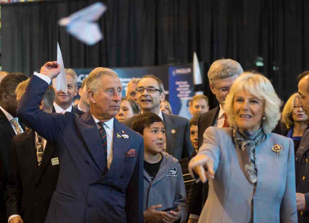 Paul Chiasson / The Canadian Press
Prince Charles, left, and his wife Camilla throw paper airplanes with Prime Minister Stephen Harper (obscured) at the Stevenson Hangar.