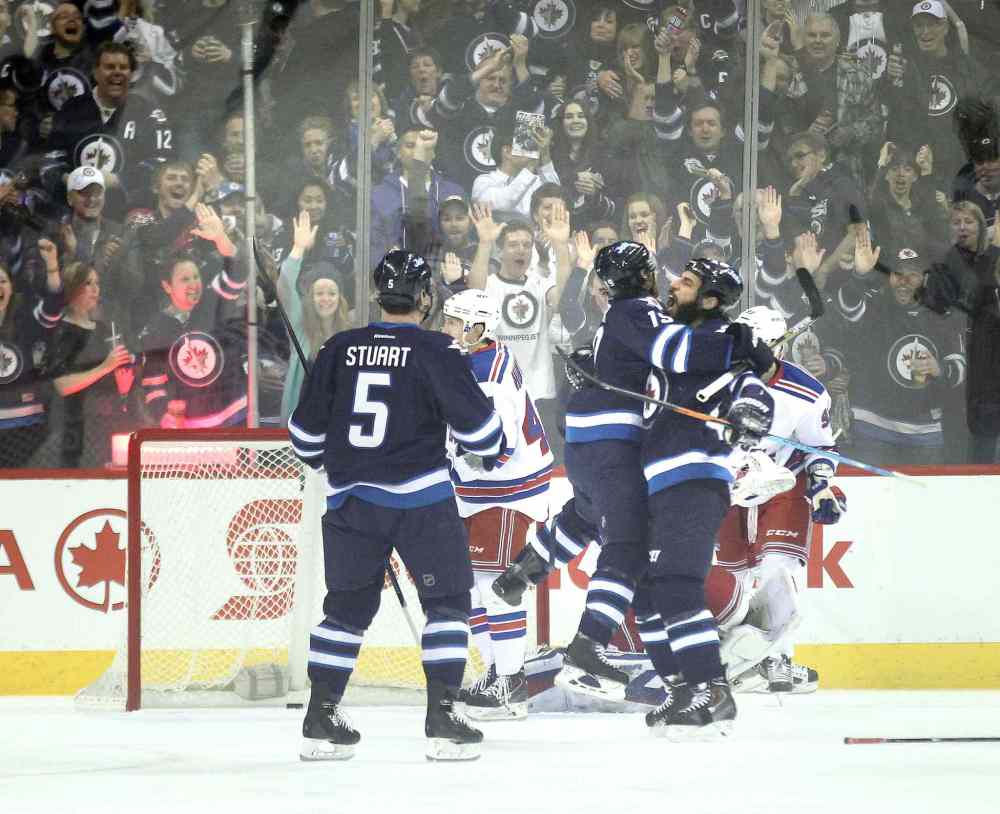 Phil Hossack / Winnipeg Free Press
Winnipeg Jets Jim Slater and Chris Thorburn embrace after Slater's opening goal early in the first period against the New York Rangers Tuesday.