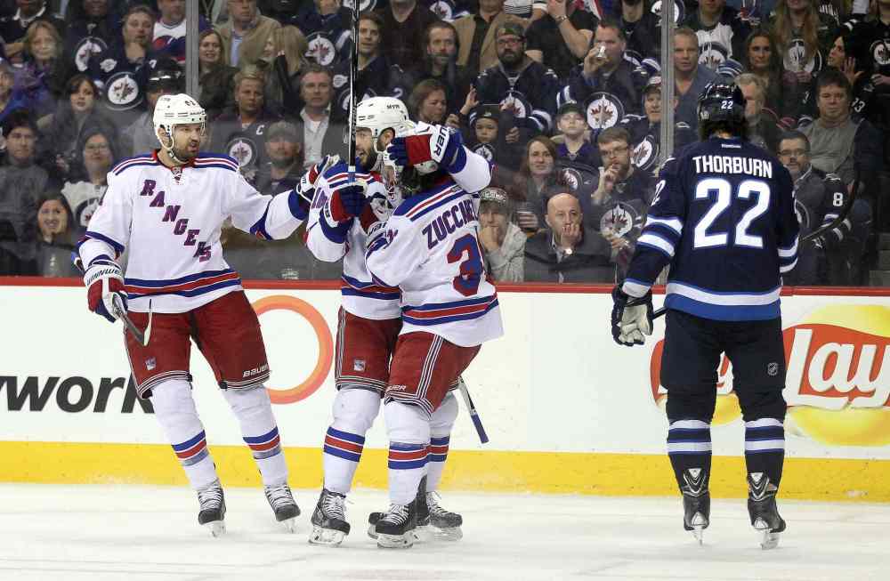 Phil Hossack / Winnipeg Free Press
New York Rangers Rick Nash (from left) Derick Brassard and goal scorer Mats Zuccarello celebrate their answering goal against the Winnipeg Jets in the first period of Tuesday's game as Chris Thorburn skates away.