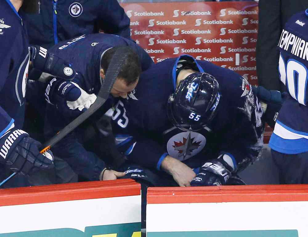 John Woods / The Canadian Press
Winnipeg Jets Mark Scheifele (55) is treated on the bench after blocking a New York Rangers shot during first period.