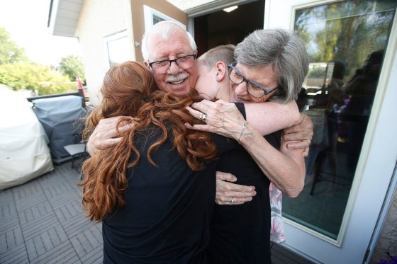 CPRichard and Linda Davis hug their grandchildren Miles and Linda Carnegie for the first time in fifteen months after Manitoba lifted some COVID-19 restrictions. (John Woods / The Canadian Press files)