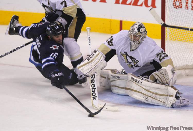 Pittsburgh Penguins goaltender Marc-Andre Fleury tries to concentrate with a busy goalmouth during third-period action. (Boris Minkevich / Winnipeg Free Press)