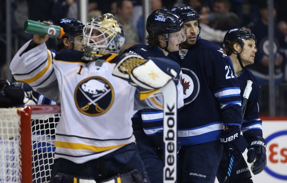 Trevor Hagan / The Canadian Press
Winnipeg Jets' Devin Setoguchi (obscured), rear left to right, Jacob Trouba, Chris Thorburn and Olli Jokinen celebrate after Trouba scored on Buffalo Sabres' goaltender Jhonas Enroth (#1) during second period at the MTS Centre.