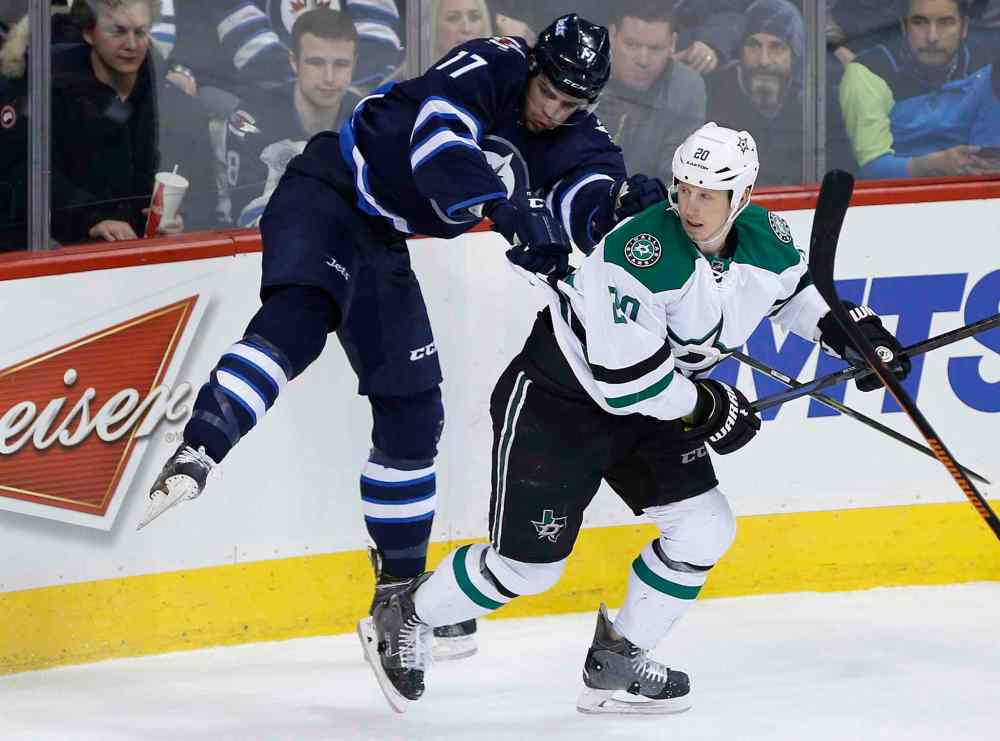John Woods / The Canadian Press
Dallas Stars' Cody Eakin (20) checks Winnipeg Jets' Adam Lowry (17) in the first period.