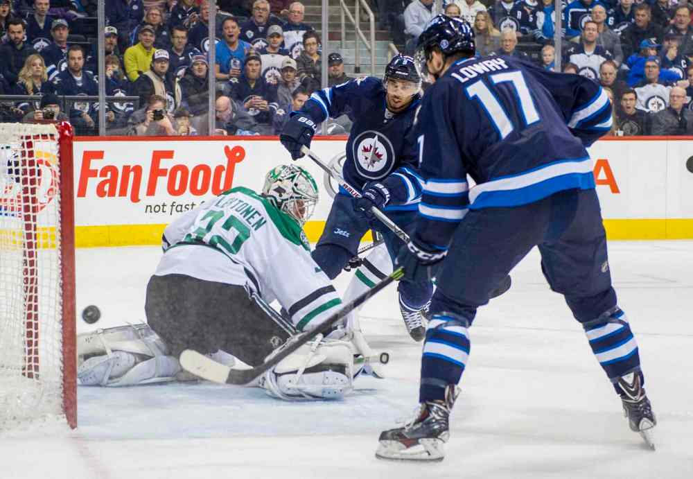 David Lipnowski / Winnipeg Free Press
Dallas Stars goaltender Kari Lehtonen (#32) stops the shot as Winnipeg Jets Evander Kane (#9) and Adam Lowry (#17) look on during second period.