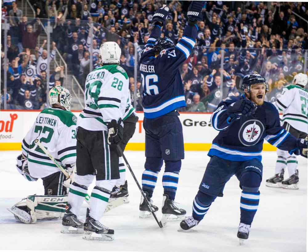 David Lipnowski / Winnipeg Free Press
Winnipeg Jets Bryan Little (#18) and Blake Wheeler (#26) celebrate Andrew Ladd's second-period goal against the Dallas Stars Saturday.