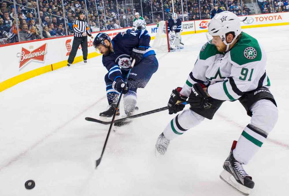 DAVID LIPNOWSKI / WINNIPEG FREE PRESS
Winnipeg Jets Zach Bogosian (#44) fights for the puck against Dallas Stars Tyler Sequin during the third period of Saturday's game. The Stars won 5-2.
