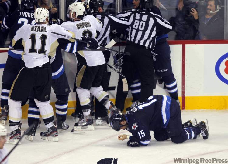 Tanner Glass of the Winnipeg Jets gets it in the face during third-period. (Boris Minkevich / Winnipeg Free Press)